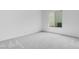Bedroom featuring a large window, plush carpeting and neutral paint at 5779 N 207Th Ave, Buckeye, AZ 85396
