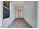 Inviting entryway with a decorative paver floor leading to a light wood front door at 5779 N 207Th Ave, Buckeye, AZ 85396
