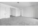 Bright, spacious living room with neutral carpet and a view into the foyer and hallway at 5779 N 207Th Ave, Buckeye, AZ 85396