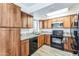 Well-lit kitchen featuring wood cabinets, granite countertops, and stainless steel appliances at 6262 E Brown Rd # 30, Mesa, AZ 85205