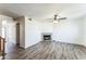 Bright living room features a ceiling fan and a cozy fireplace at 6262 E Brown Rd # 30, Mesa, AZ 85205