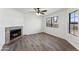 Bright living room with a fireplace, large windows, and wood-look floors at 6262 E Brown Rd # 30, Mesa, AZ 85205