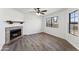 Living room boasting a fireplace, natural light, and wood-look floors at 6262 E Brown Rd # 30, Mesa, AZ 85205