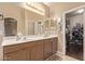 Large bathroom featuring double sinks, a large mirror, and an open closet space at 6350 S Wilson Dr, Chandler, AZ 85249