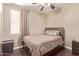 Cozy bedroom features wood floors, a queen bed, and a large window for plenty of natural light at 6350 S Wilson Dr, Chandler, AZ 85249