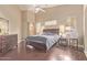 This spacious bedroom features wood floors, neutral walls, a ceiling fan, and plenty of natural light at 6350 S Wilson Dr, Chandler, AZ 85249