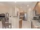 Modern kitchen with stainless steel appliances, granite countertops, and breakfast bar at 6350 S Wilson Dr, Chandler, AZ 85249