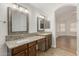 Bathroom with dual sinks, granite countertops, and framed mirrors at 654 W Natal Cir, Mesa, AZ 85210