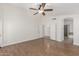 A spacious bedroom with wood floors, ceiling fan and bathroom entrance at 654 W Natal Cir, Mesa, AZ 85210