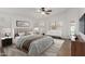 Bedroom with light walls, wood floor, ceiling fan, and backyard views at 654 W Natal Cir, Mesa, AZ 85210