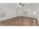 A spacious bedroom with wood floors, a ceiling fan, and views of the backyard pool at 654 W Natal Cir, Mesa, AZ 85210