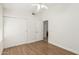 Well-lit bedroom with wood floors, closet, and neutral paint creating a calm space at 654 W Natal Cir, Mesa, AZ 85210