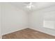 Bright bedroom with wood-look floors, baseboards, and window providing natural light at 654 W Natal Cir, Mesa, AZ 85210