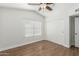 Bright bedroom with wood-look floors, closet, and window at 654 W Natal Cir, Mesa, AZ 85210