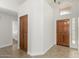 Open foyer with tile flooring, coat closet, and wood front door with transom window at 654 W Natal Cir, Mesa, AZ 85210