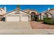 Charming single-story home with a well-maintained front yard and a three-car garage at 654 W Natal Cir, Mesa, AZ 85210