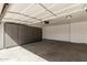 Well-lit garage with multiple storage cabinets along the wall offering organization and functionality at 654 W Natal Cir, Mesa, AZ 85210