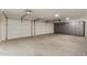 Spacious garage featuring white doors, overhead lighting, and ample storage cabinets at 654 W Natal Cir, Mesa, AZ 85210