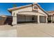 Exterior shot of a two-car garage, door open, showcasing ample parking and storage space at 654 W Natal Cir, Mesa, AZ 85210