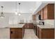 Open-concept kitchen featuring granite countertops, tile backsplash, and stainless steel appliances at 654 W Natal Cir, Mesa, AZ 85210