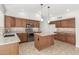 Spacious kitchen featuring ample cabinetry, tile flooring, and stainless steel appliances at 654 W Natal Cir, Mesa, AZ 85210