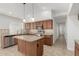 Well-equipped kitchen featuring granite counters, center island, tile backsplash, and stainless steel appliances at 654 W Natal Cir, Mesa, AZ 85210