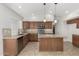 Kitchen with granite countertops, tile backsplash, stainless steel appliances, and center island at 654 W Natal Cir, Mesa, AZ 85210