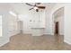 Bright living room with tiled floors, ceiling fan, high ceilings, and a bar at 654 W Natal Cir, Mesa, AZ 85210