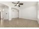 Open living room with tile flooring, high ceilings, ceiling fan, and archways at 654 W Natal Cir, Mesa, AZ 85210