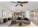 Spacious living room featuring a modern sectional sofa and open layout to the dining and kitchen areas at 654 W Natal Cir, Mesa, AZ 85210