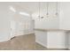 Bright living room with tile flooring, stylish pendant lights, and sliding glass door at 654 W Natal Cir, Mesa, AZ 85210