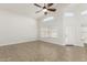 Bright living room featuring vaulted ceiling, ceiling fan, tile flooring, and ample natural light at 654 W Natal Cir, Mesa, AZ 85210