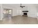Open living room with tile floor, fireplace, and sliding glass door offering access to outdoor pool at 654 W Natal Cir, Mesa, AZ 85210