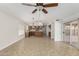 Large living room leading into kitchen, featuring tile flooring and abundant natural light at 654 W Natal Cir, Mesa, AZ 85210