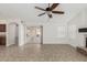 Spacious living room boasting tile flooring, sliding glass door to patio, and cozy fireplace at 654 W Natal Cir, Mesa, AZ 85210