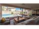 Comfortable patio area with seating and outdoor décor that provides relaxation by the pool at 654 W Natal Cir, Mesa, AZ 85210