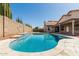 Enjoy this backyard pool with stone trim and blue tile in a private setting at 654 W Natal Cir, Mesa, AZ 85210
