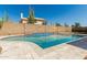 Sparkling pool surrounded by desert landscaping and block wall, perfect for outdoor relaxation at 654 W Natal Cir, Mesa, AZ 85210