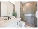 Modern bathroom featuring a glass-enclosed shower and a stylish vanity with a black framed mirror at 670 E Woburn Ln, Phoenix, AZ 85085