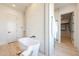 Bright bathroom showcasing soaking tub, walk-in shower, modern fixtures and stylish vanity at 670 E Woburn Ln, Phoenix, AZ 85085