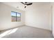 Bright bedroom featuring a large window offering natural light and scenic neighborhood views at 670 E Woburn Ln, Phoenix, AZ 85085