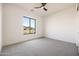 Bright bedroom highlighting a large window with scenic views and a ceiling fan for comfort at 670 E Woburn Ln, Phoenix, AZ 85085