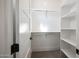 Walk-in closet boasting custom shelving and ample storage space for clothes and accessories at 670 E Woburn Ln, Phoenix, AZ 85085
