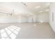 Expansive and bright garage with white walls and epoxy floors, ideal for multiple vehicles or workshop at 670 E Woburn Ln, Phoenix, AZ 85085