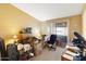 Bedroom filled with boxes, desk, office chair, and sliding glass door at 6960 W Peoria Ave # 29B, Peoria, AZ 85345
