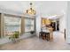 Bright dining room with large windows, tiled flooring and a modern chandelier at 6960 W Peoria Ave # 29B, Peoria, AZ 85345