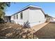 Exterior view of a single story home featuring gravel landscaping and mature shade trees at 6960 W Peoria Ave # 29B, Peoria, AZ 85345
