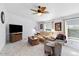 Cozy living room with comfortable seating, ceiling fan, and plenty of natural light at 6960 W Peoria Ave # 29B, Peoria, AZ 85345