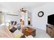 Bright living room features neutral paint, ceiling fan, wood-look flooring, and a comfortable sofa with accent pillows at 6960 W Peoria Ave # 29B, Peoria, AZ 85345