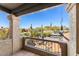 Balcony featuring desert landscaping and patio set with wrought iron railing at 7220 E Mary Sharon Dr # 116, Scottsdale, AZ 85266